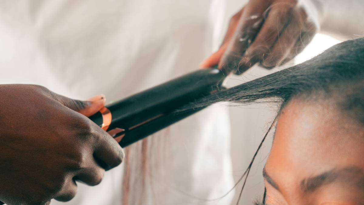 woman applying hair taming gel to damp curls for frizz control